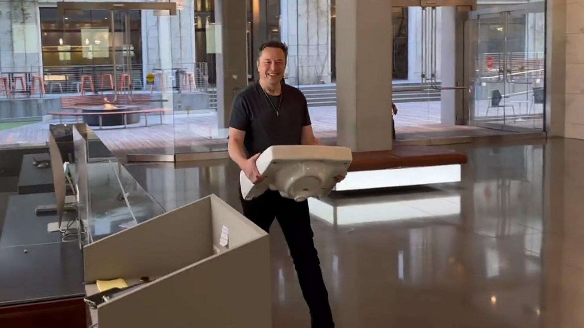 Elon Musk carrying a sink into Twitter HQ